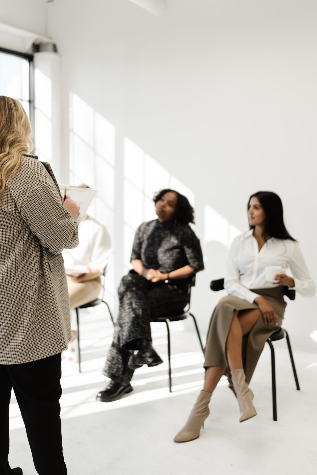 People gathered in a bright modern space for a workshop session